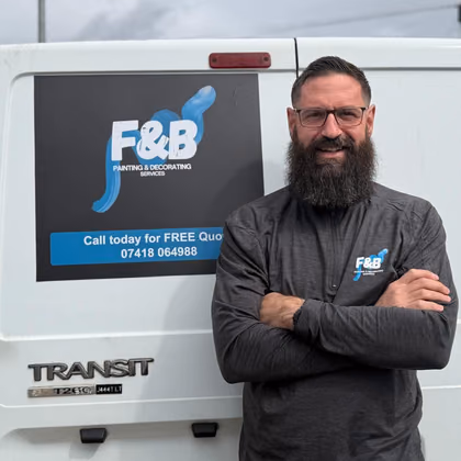 Owner standing proudly with the F&B painting and decorating van