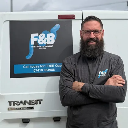 Owner standing proudly with the F&B painting and decorating van